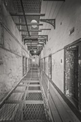 Kilmainham Gaol prison cell hallway with partial metal grid floors- Dublin Ireland - Sepia_0.jpg